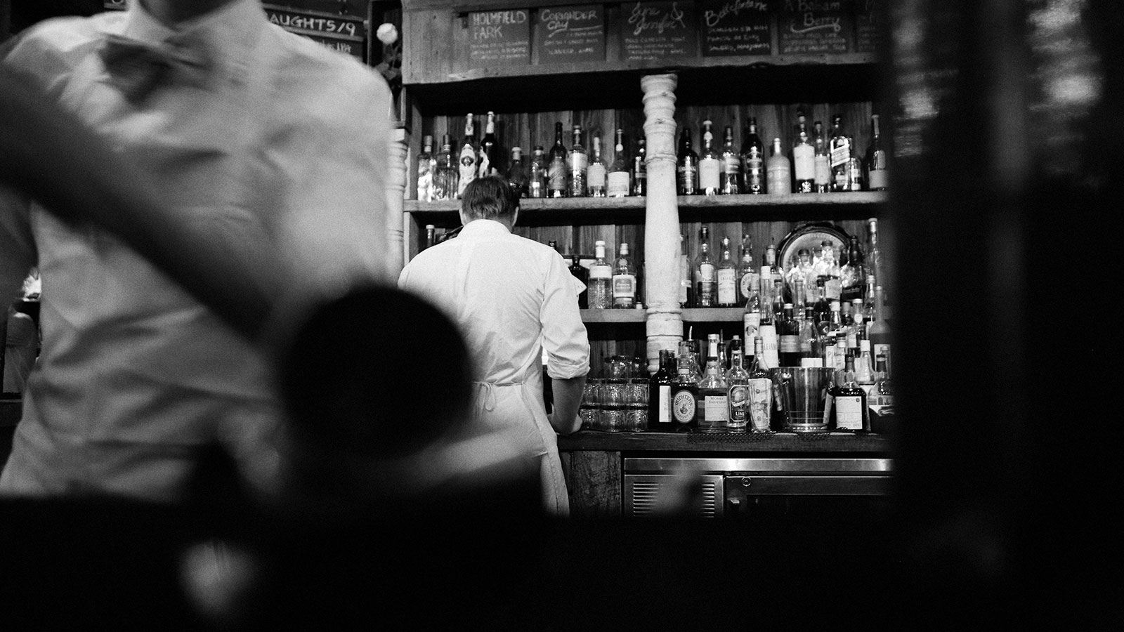 Waitstaff behind bar